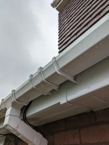 Spotless gutter pipes, soffits, and fascias after a thorough professional cleaning service, restoring the exterior to a like-new condition.