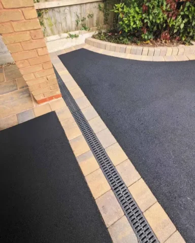 Restored tarmac driveway with a smooth, vibrant finish after professional cleaning and sealing.

